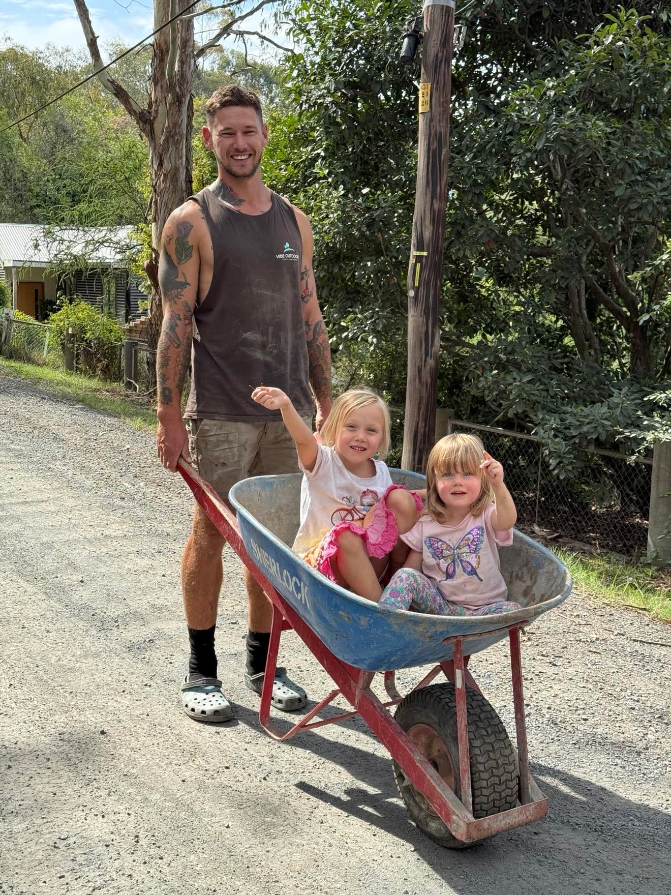 Tony with his kids in a wheelbarrow - the heart of Vibe Outdoors